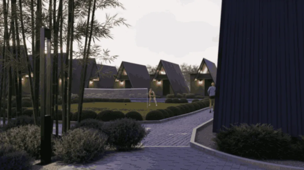 A landscaped path curves past modern, triangular-roofed cabins. Two people walk in the green area surrounded by bushes and trees at dusk.